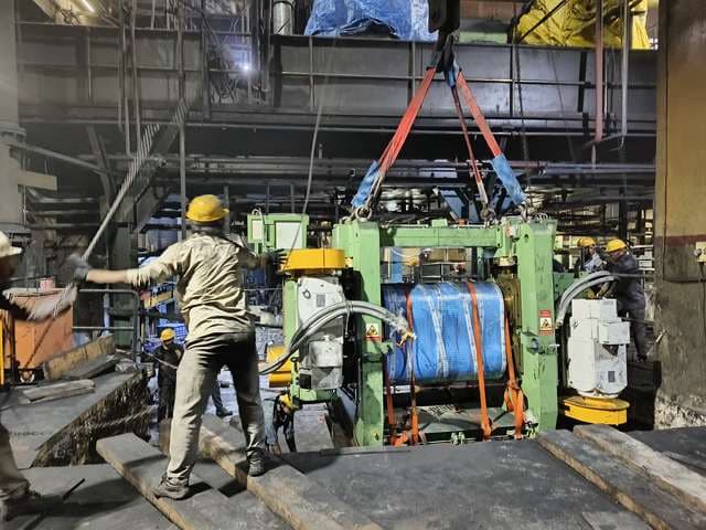 Rolling mill stand slung and rigged inside an operating steel plant.